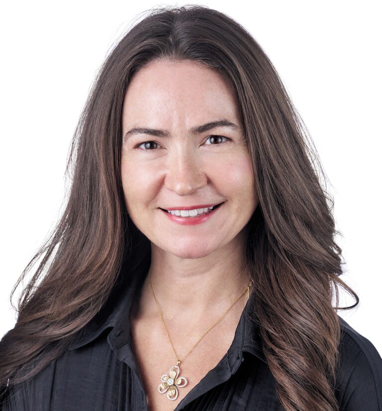 A headshot of associate associate Kate Duffy. She has long brown hair and is wearing a black shirt.