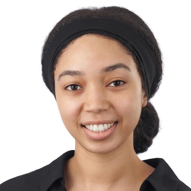 A headshot of associate Kyla Taylor. She has long black hair pulled back with a black headband, and she is wearing a black collared shirt.