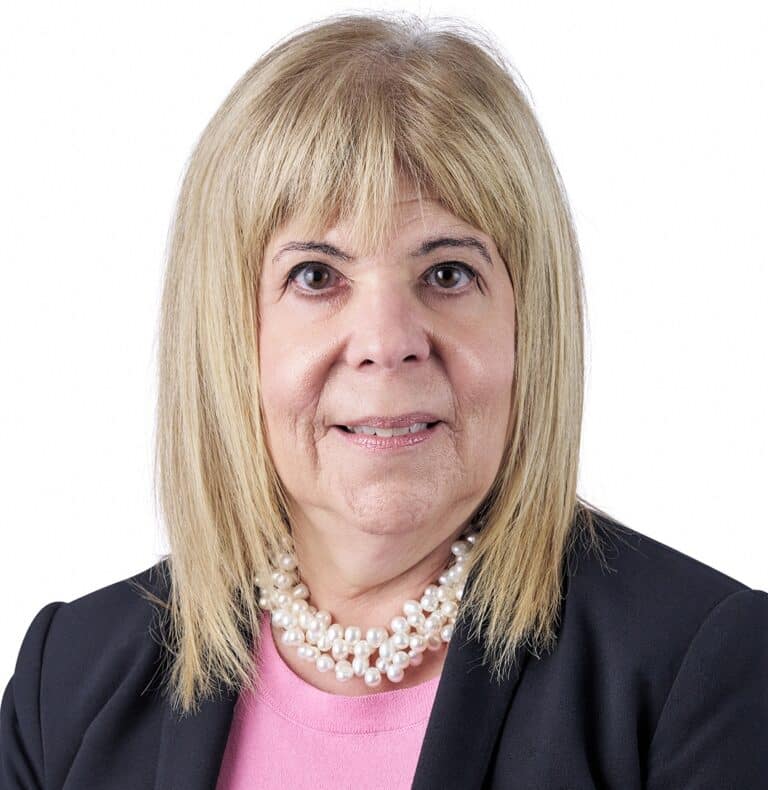 A headshot of associate Nancy Fanucchi. She has shoulder length blonde hair and is wearing a black blazer.
