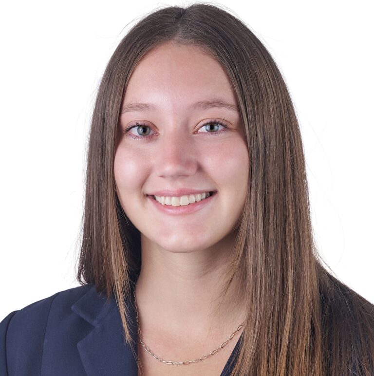 A headshot of associate Aimee Buffington. She has long brown hair and is wearing a navy blazer.