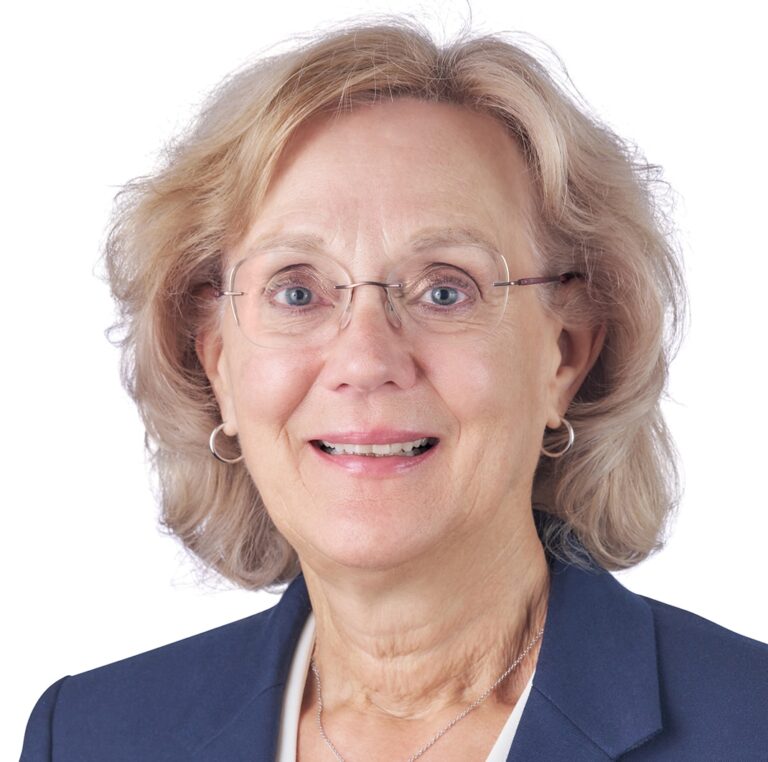 A headshot of associate Ellen Shea. She has short blonde hair and she is wearing a navy blazer.