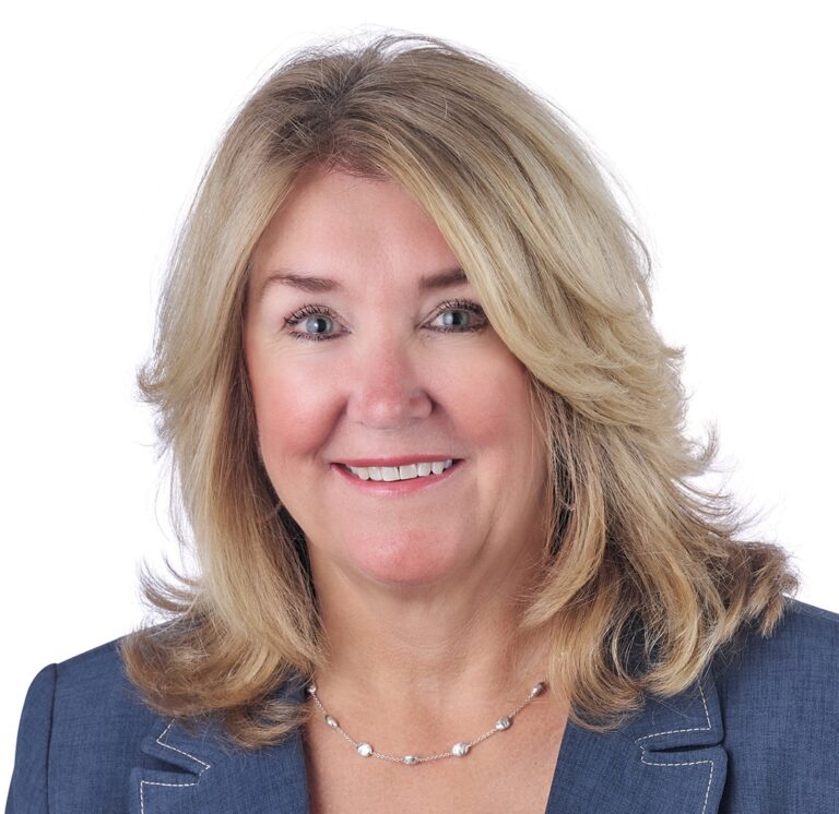 A headshot of associate Jackie Blue. She has shoulder length blonde hair and is wearing a denim blazer.