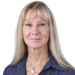 A headshot of associate Jackie Reeves. She has long blonde hair and is wearing a blue shirt.