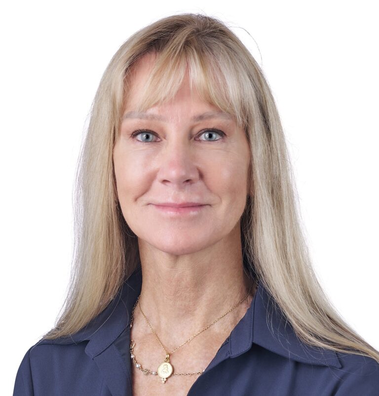 A headshot of associate Jackie Reeves. She has long blonde hair and is wearing a blue shirt.