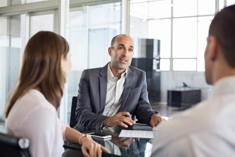 Financial advisor discussing the stock market with clients