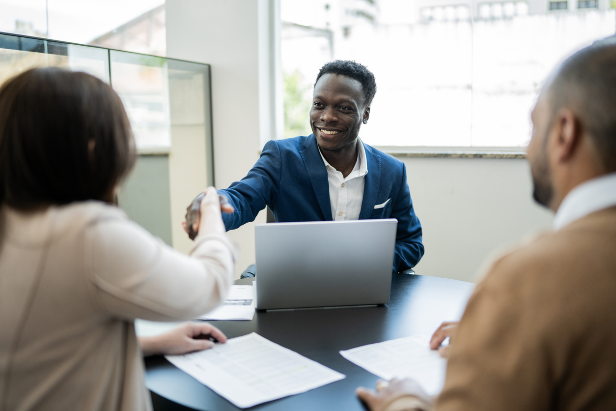 A man shaking hands with clients.